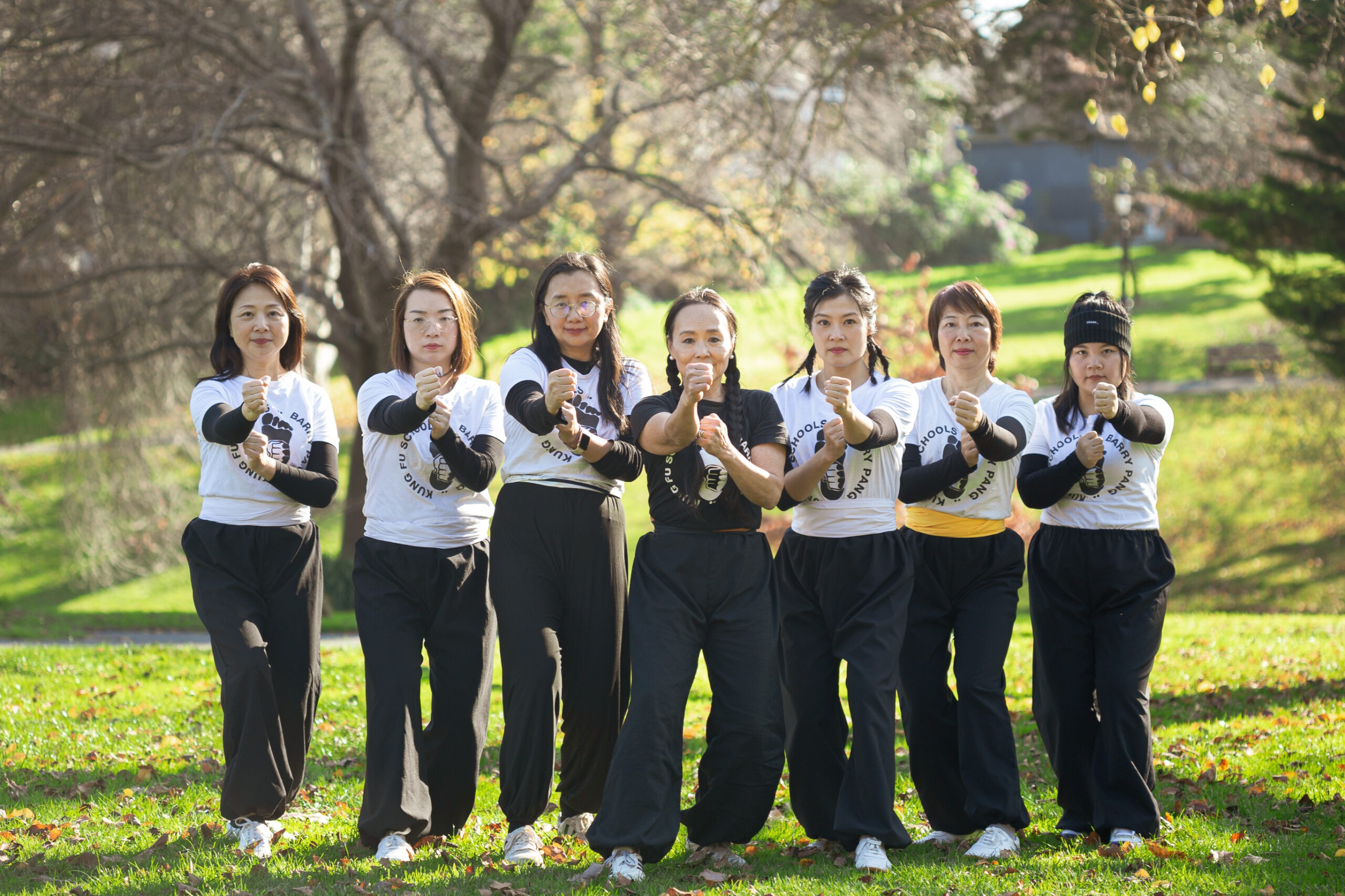 Anne Pang with her female kung fu students. Group pose in the gardens.